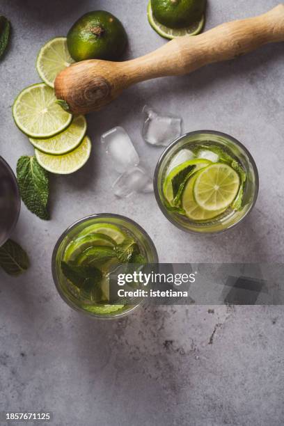 ingredients for mojito,  lime, mint, sugar, ice on gray background - caipirinha stock pictures, royalty-free photos & images