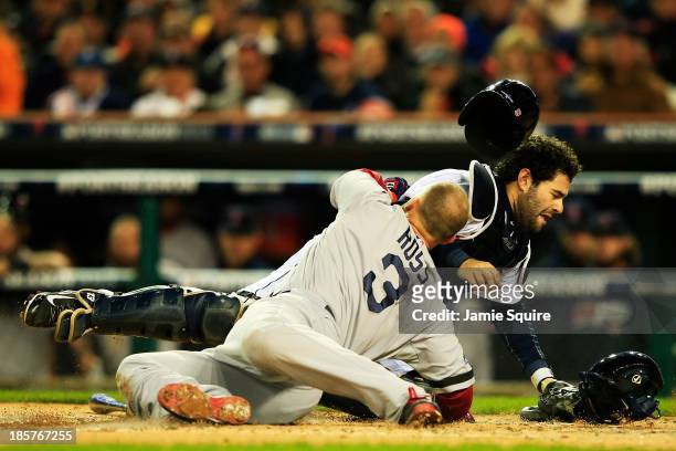 David Ross of the Boston Red Sox is out at home by Alex Avila of the Detroit Tigers in the second inning of Game Five of the American League...