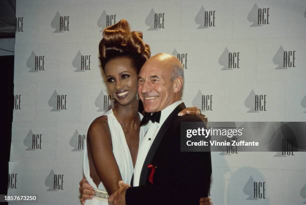 Somali model Iman, wearing a white evening gown, and British actor Patrick Stewart, who wears a tuxedo and bow tie, in the press room of the 13th...