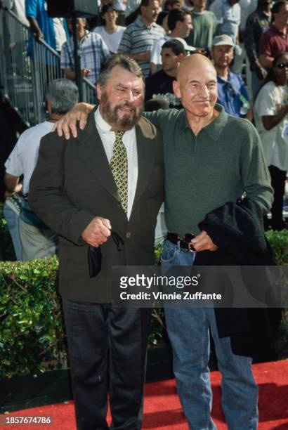 British actor Brian Blessed, wearing a dark grey blazer over white shirt with a patterned tie, and British actor Patrick Stewart, who wears a...