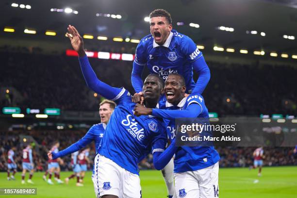 Amadou Onana of Everton celebrates with Abdoulaye Doucoure and Ben Godfrey after scoring their team's first goal during the Premier League match...