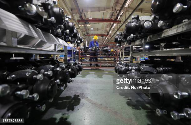 Employees are assembling a steering bridge at a production workshop in Anqing, Anhui province, China, on December 12, 2023.