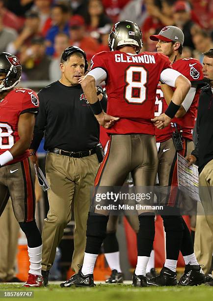 Mike Glennon of the Tampa Bay Buccaneers talks with head coch Greg Schiano during a game against the Carolina Panthers at Raymond James Stadium on...