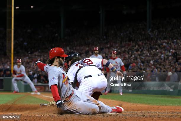 Pete Kozma of the St. Louis Cardinals scores in the seventh inning against the Boston Red Sox during Game Two of the 2013 World Series at Fenway Park...