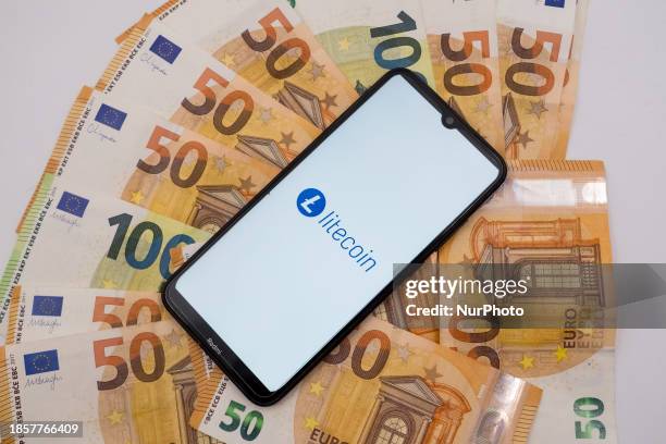 The Litecoin logo is being displayed on a smartphone screen that is placed on 50 and 100 Euro bills in Athens, Greece, on December 18, 2023.