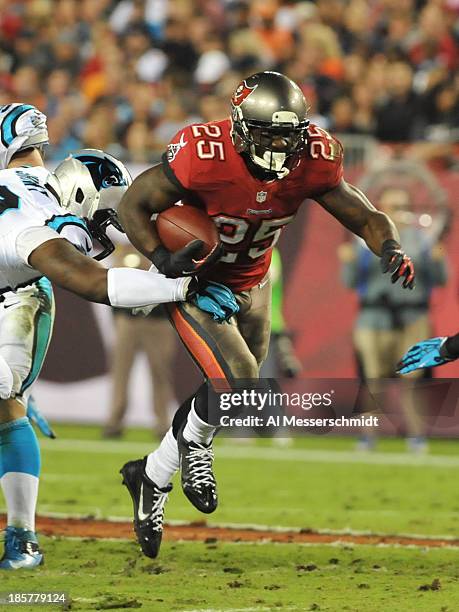 Running back Mike James of the Tampa Bay Buccaneers rushes upfield against the Carolina Panthers October 24, 2013 at Raymond James Stadium in Tampa,...