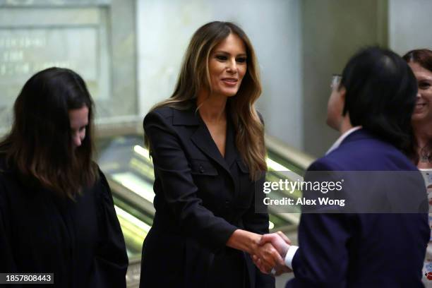 Former U.S. First lady Melania Trump shakes hands with new U.S. Citizens during a naturalization ceremony at the National Archives on December 15,...