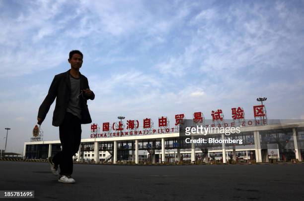 Man walks past the gate to China Pilot Free Trade Zone's Pudong free trade zone in Shanghai, China, on Thursday, Oct. 24, 2013. The area is a testing...