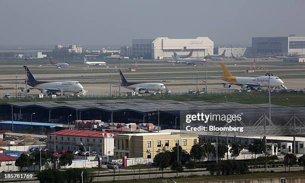 Cargo aircraft parked at Shanghai Pudong International Airport are seen from an observation deck at China Pilot Free Trade Zone's Pudong free trade...