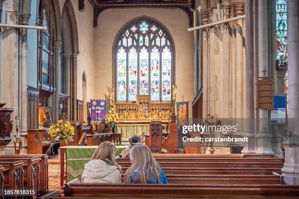 people sitting in a old church - church stock pictures, royalty-free photos & images