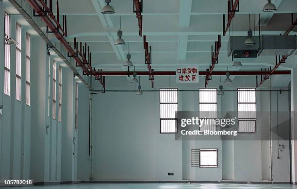 Storage area stands empty in a logistics center at China Pilot Free Trade Zone's Pudong free trade zone in Shanghai, China, on Thursday, Oct. 24,...