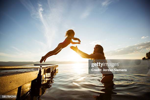 swimming in a lake. - jumping into water stock pictures, royalty-free photos & images