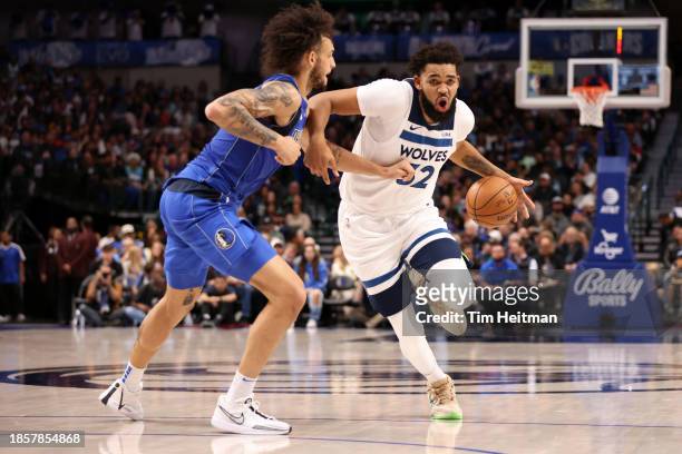 Karl-Anthony Towns of the Minnesota Timberwolves dribbles the ball against Dereck Lively II of the Dallas Mavericks in the first half at American...