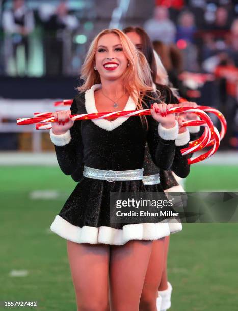 Members of the Las Vegas Raiderettes cheerleading squad perform a Christmas-themed routine at halftime of the Raiders' game against the Los Angeles...