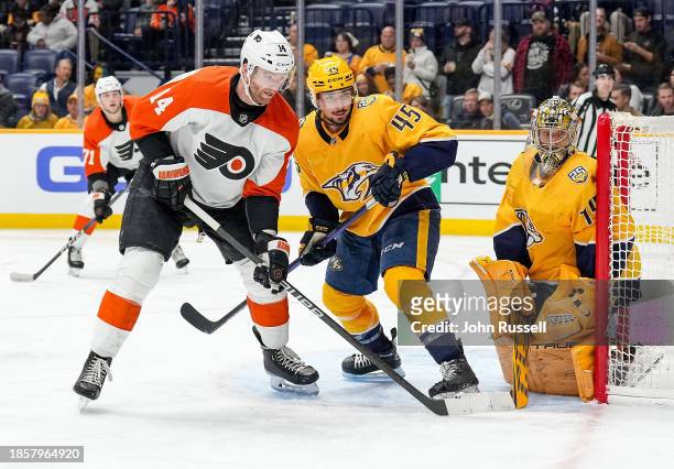 Sean Couturier of the Philadelphia Flyers battles in front of the net against Alexandre Carrier and Juuse Saros of the Nashville Predators during an...