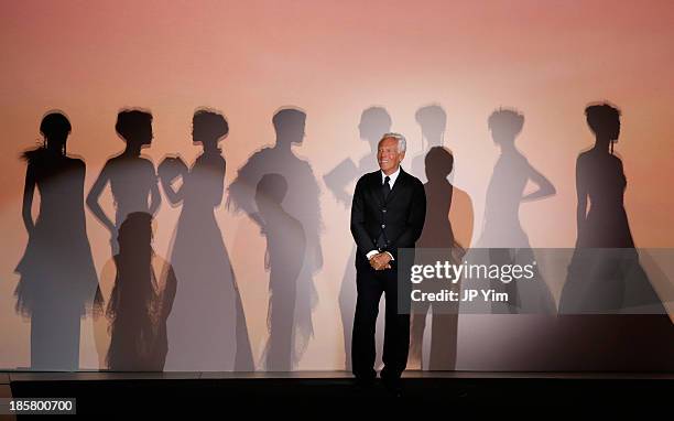 Designer Giorgio Armani acknowledges the audience after his runway show at the Giorgio Armani One Night Only NYC at Hudson's River Park SuperPier on...