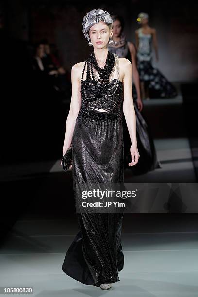 Model walks the runway at the Giorgio Armani One Night Only NYC at Hudson's River Park SuperPier on October 24, 2013 in New York City. Armani...