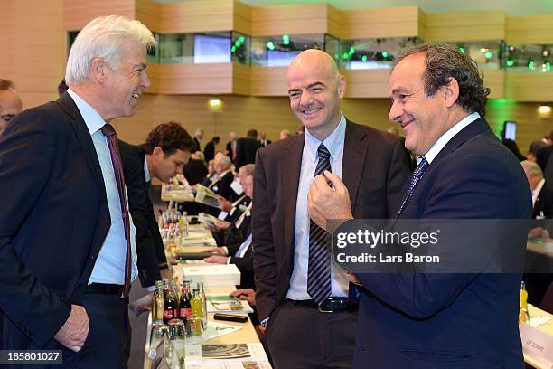 Rainer Holzschuh, publisher of the Kicker Sportmagazin, talks to UEFA president Michel Platini and UEFA general secretary Giovanni Infantino during...