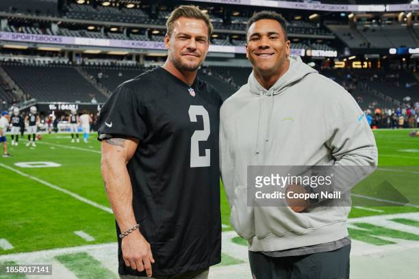 Alan Ritchson and Christian Covington pose for a photo before kickoff between the Las Vegas Raiders and Los Angeles Chargers at Allegiant Stadium on...