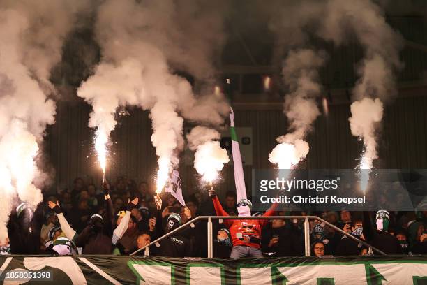 Fans release flares in the stands during the Bundesliga match between Borussia Mönchengladbach and SV Werder Bremen at Borussia Park Stadium on...