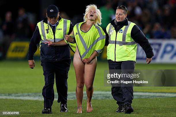 Female streaker is removed by sercurity during the ITM Cup Championship FInal match between Tasman and Hawke's Bay at Trafalgar Park on October 25,...