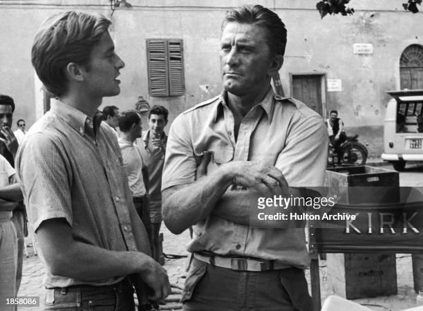 American actor Kirk Douglas and his son American actor Michael Douglas on the set of the film, 'Cast a Giant Shadow,' directed by Melville Shavelson,...
