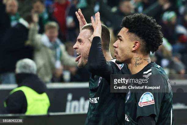 Marvin Ducksch of Werder Bremen celebrates scoring their team's second goal with teammate Justin Njinmah during the Bundesliga match between Borussia...