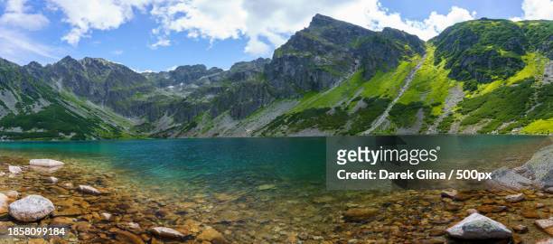 scenic view of lake by mountains against sky - juli bildbanksfoton och bilder
