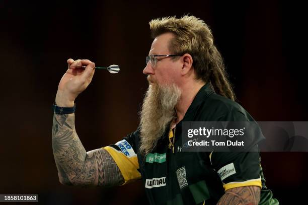 Simon Whitlock of Australia throws in his first round match against Paolo Nebrida of the Philippines on Day One of 2023/24 Paddy Power World Darts...