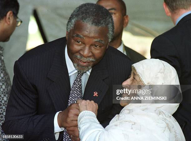 South African president Thabo Mbeki congratulates former District 6 resident 85 year-old Mrs Fatima Benting during a homecoming ceremony in District...