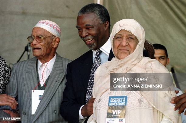South African president Thabo Mbeki congratulates former District 6 residents 100 year-old Mr Bessier and 85 year-old Mrs Fatima Benting during a...