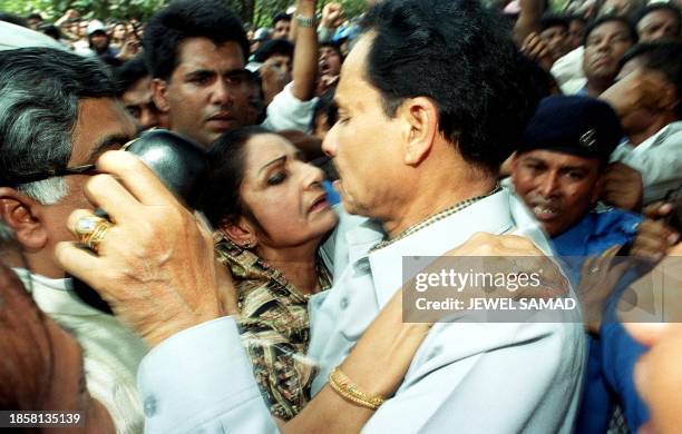 Deposed Bangladeshi president Hussain Muhammad Ershad , who surrendered before being taken to jail, embraces his wife Raushan Ershad , 20 November...