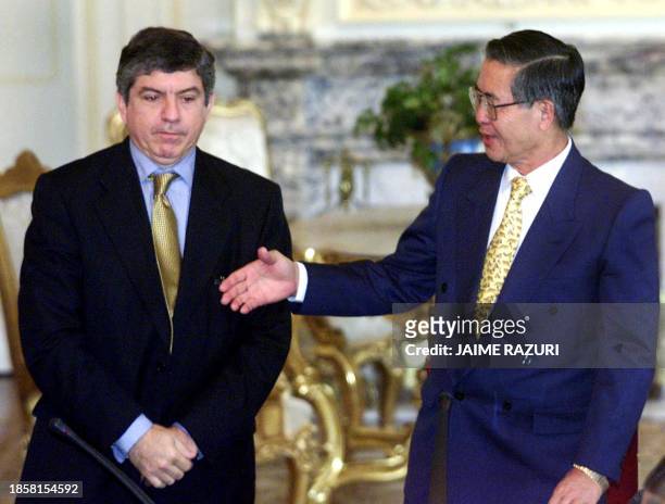 Peruvian President Alberto Fujimori extends his hand to Cesar Gaviria , Secretary General of the Organization of American States 25 October 2000 at...