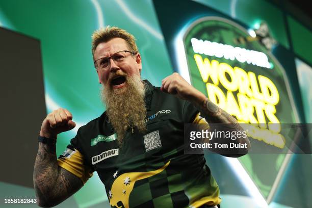 Simon Whitlock of Australia celebrates victory in his first round match against Paolo Nebrida of the Philippines on Day One of 2023/24 Paddy Power...