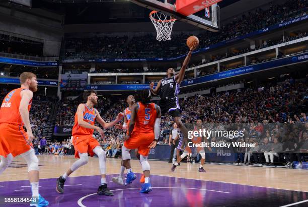 De'Aaron Fox of the Sacramento Kings drives to the basket during the game against the Oklahoma City Thunder on December 14, 2023 at Golden 1 Center...