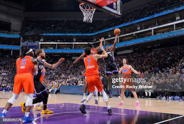 De'Aaron Fox of the Sacramento Kings drives to the basket during the game against the Oklahoma City Thunder on December 14, 2023 at Golden 1 Center...