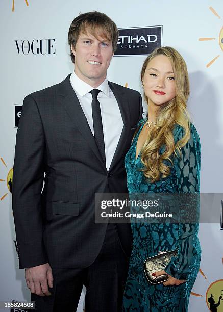 Actress Devon Aoki and James Bailey arrive at the Dream For Future Africa Foundation Gala at Spago on October 24, 2013 in Beverly Hills, California.