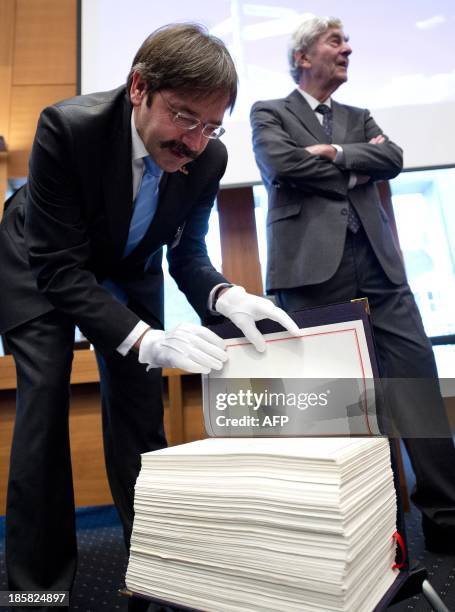 The of Governor of the Province of Limburg Theo Bovens and former Dutch Prime Minister Ruud Lubbers stand next to a copy of the 'Maastricht Treaty'...