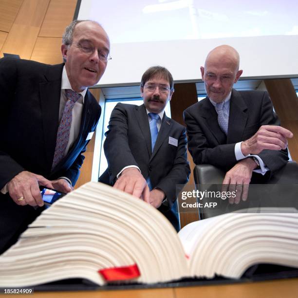 The Governor of the Province of Limburg Theo Bovens and the Director-General of the WTO, Pascal Lamy look at a copy of the 'Maastricht Treaty' during...