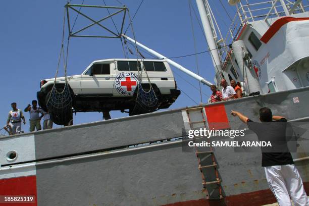 Vehicle is unloaded from a ship chartered by the International Committee of the Red Cross to transport aid supplies to southern Lebanon, 12 August...