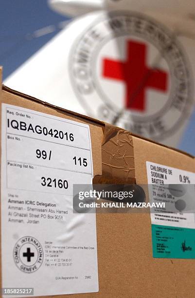 Aid boxes are seen in Amman 14 April 2004, as an International Committee of the Red Cross airplane waits to leave with medical supplies to Iraqi. The...