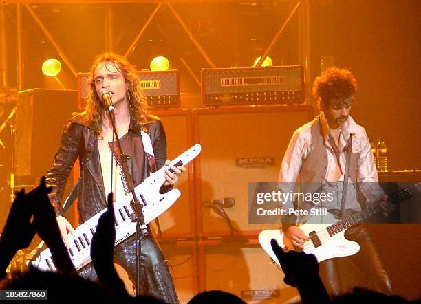 Justin Hawkins and Frankie Poullain of The Darkness perform on stage at Brixton Academy, on November 23rd, 2004 in London, England.