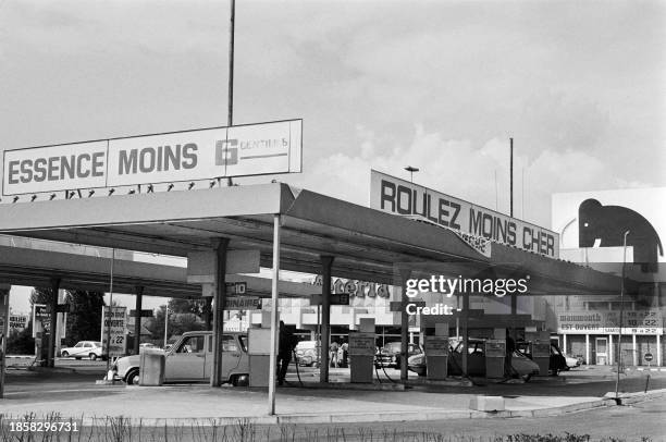 Consumers fill up their car at a Mammouth supermarket gas station where gasoline is sold cheaper, to fight against the rise in gasoline prices caused...