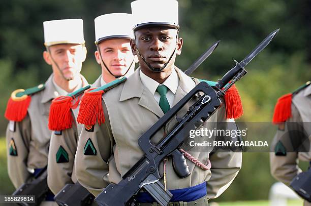 French soldiers of the 4th regiment of the Foreign Legion stand on October 25, 2013 at the Bel Air farm near the southwestern French town of...