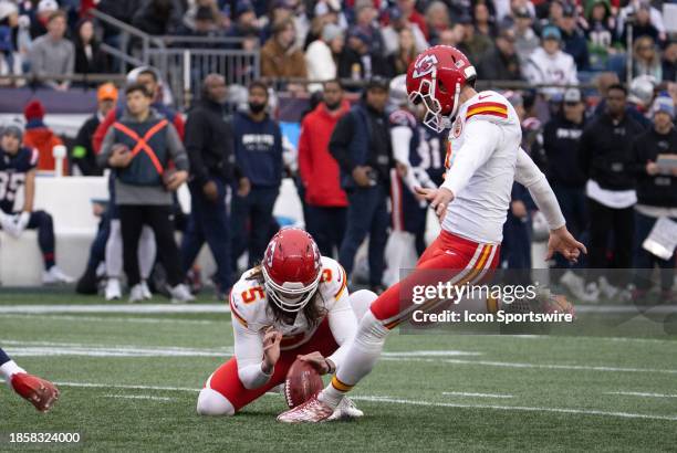 Kansas City Chiefs kicker Harrison Butker kicks from the hold of Kansas City Chiefs punter Tommy Townsend during a game between the New England...