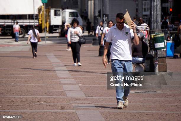 Pedestrians are walking on the Viaduto do Cha in Sao Paulo, Brazil, on a hot day with high temperatures, on November 14, 2023.