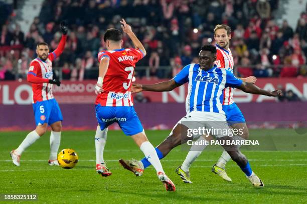 Girona's Spanish defender Miguel Gutierrez vies with Alaves' Spanish forward Samuel Omorodion during the Spanish league football match between Girona...