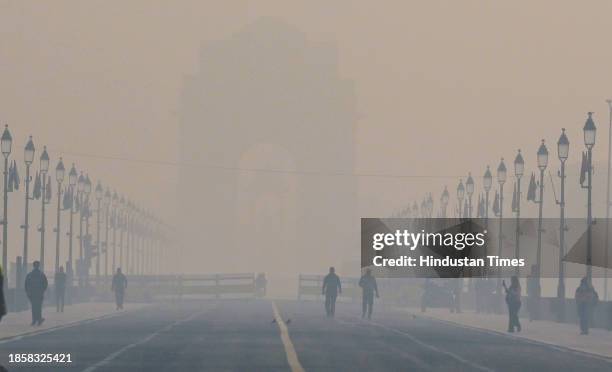 View of Kartvya Path near India Gate reveals heavy smog on a cold morning as air pollution levels rise on December 18, 2023 in New Delhi, India.