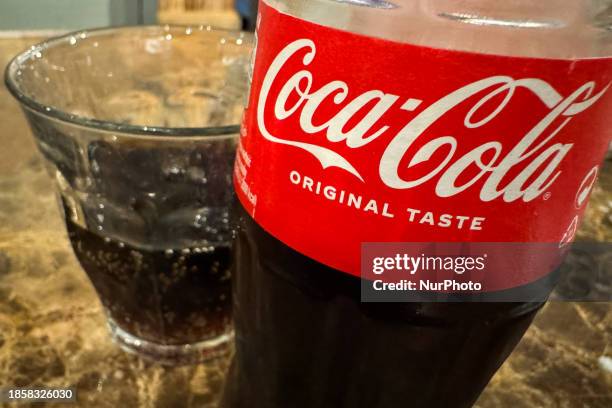 Coca-Cola bottle is seen at cafe in Krakow, Poland on December 18, 2023.