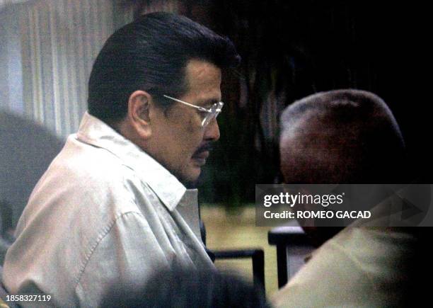 Disgraced Philippine leader Joseph Estrada arrives at the national police headquarters accompanied by lawyer Andres Narvasa to have his mugshots and...